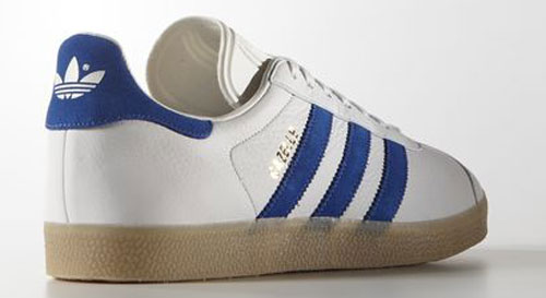 white and blue leather gazelles